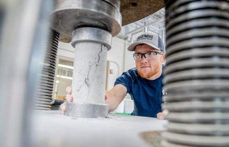 student working with a machine