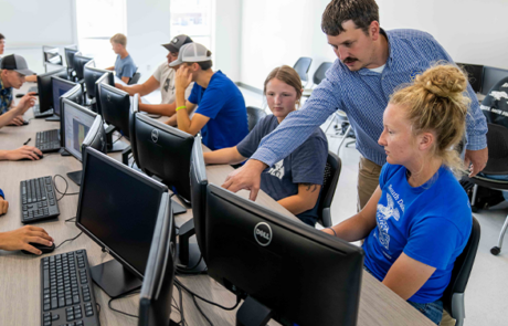 professor helping students in a classroom