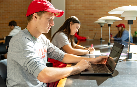 student studying in college library