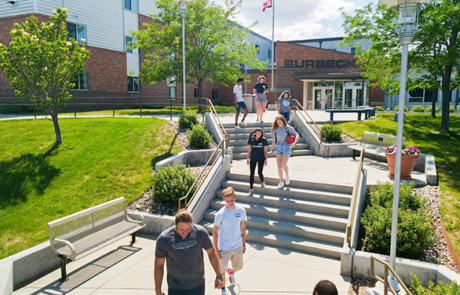 students walking down steps on campus