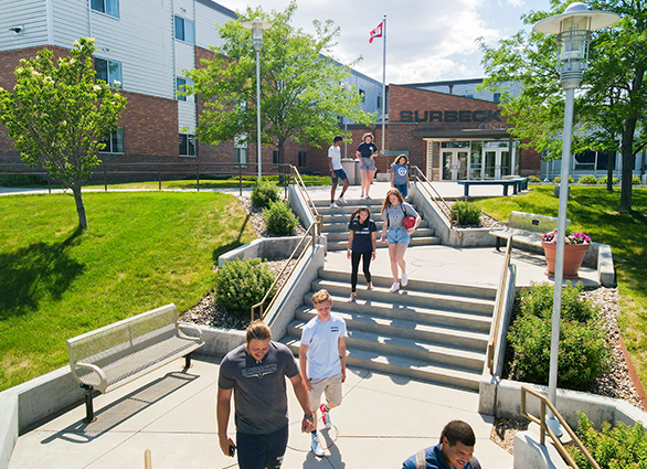 students walking down steps on campus