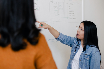 Student pointing to a whiteboard