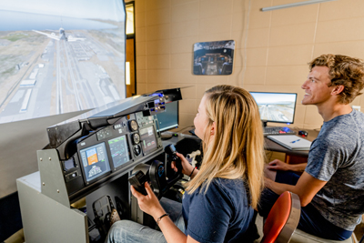Two students on a flight simulator